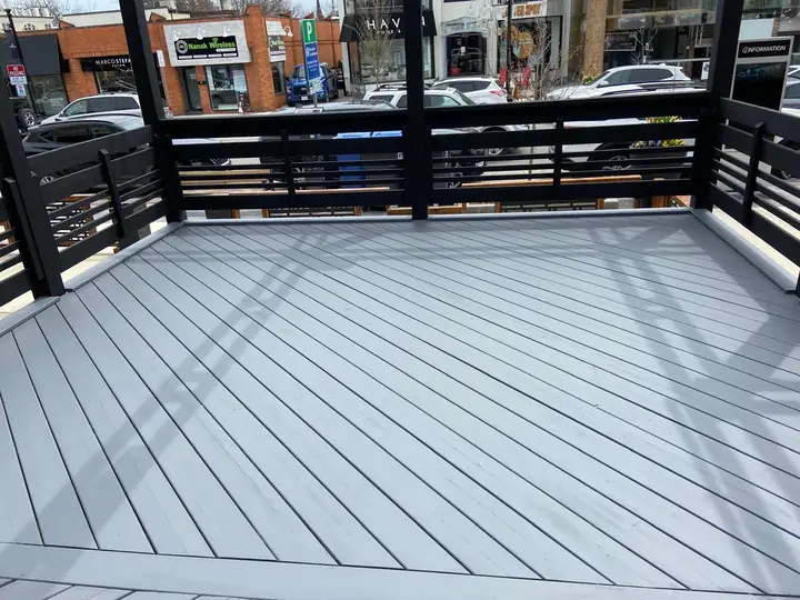 Balcony with grey deck and black railing